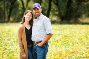 Dennis and Jessica Rau in a soybean field