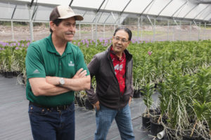 American AgCredit Lender walks with a customer through their nursery