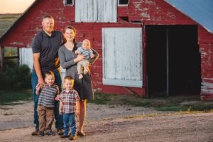 Family in front of rural barn